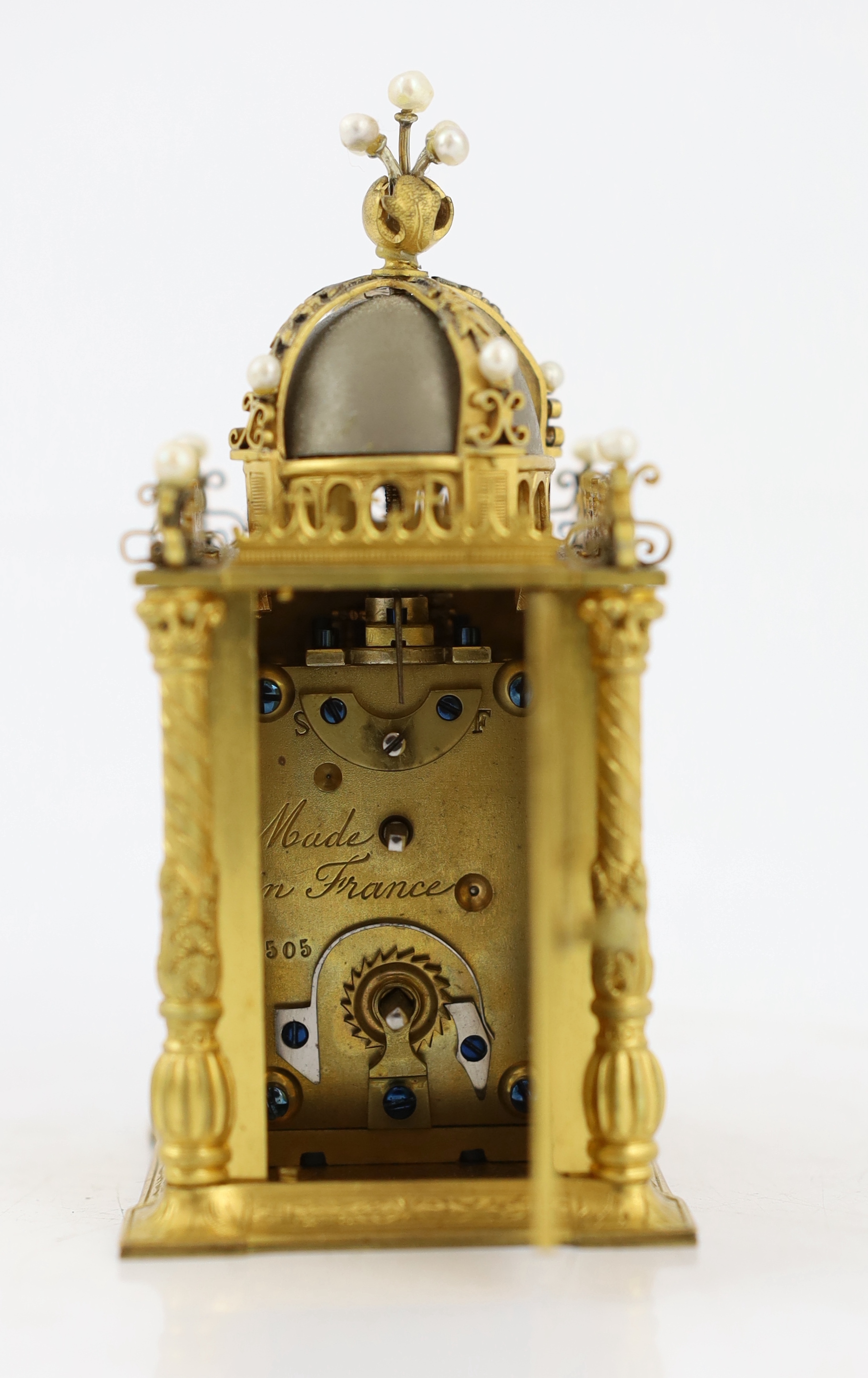 An early 20th century French miniature timepiece modelled on a 17th century domed bell clock, 4.75cm wide, 9.5cm high, with original leather travelling case